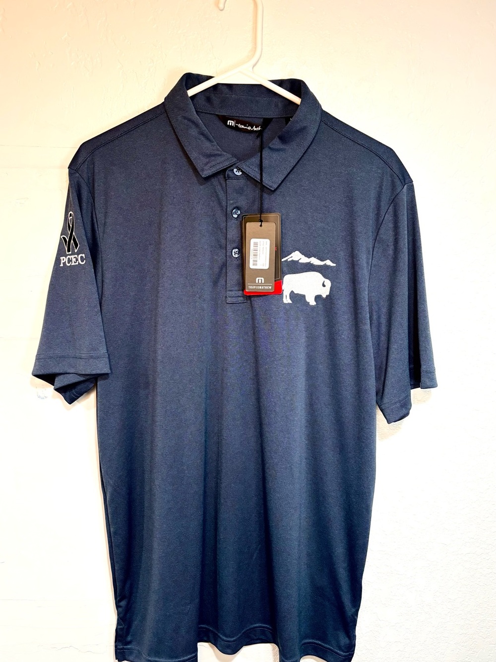 Travis Mathew Navy Polo with White Buffalo Logo